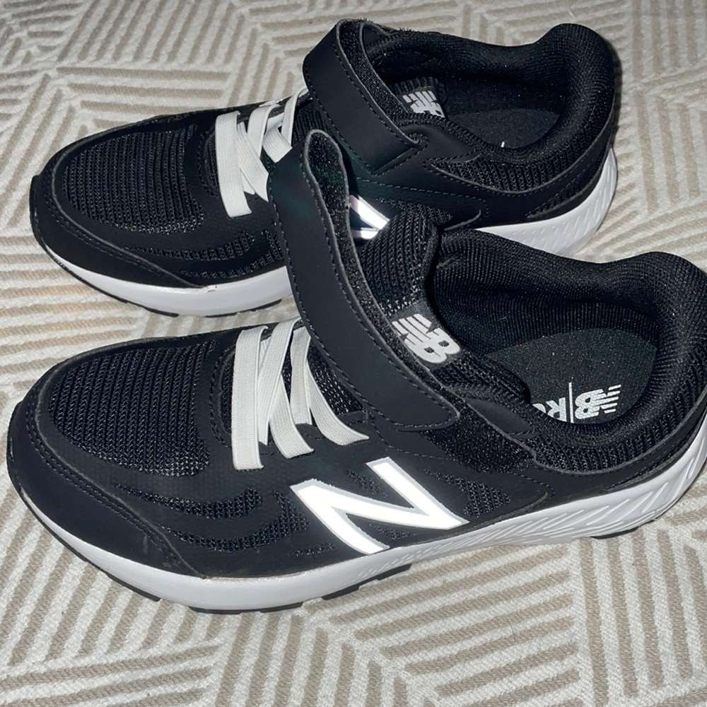 Brand new without box. New Balance black sneakers with Velcro strap. Kids size 3